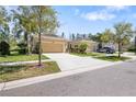 Charming single-story home with a two-car garage, lush landscaping, and a well-maintained lawn at 11714 Wrought Pine Loop, Riverview, FL 33569