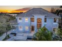 Home featuring a light blue exterior, arched entry, and manicured front yard at 12808 Harborwood Dr, Largo, FL 33774