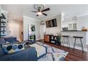 Cozy living room with modern furniture, a TV, and an open view to the kitchen at 1810 E Palm Ave # 4304, Tampa, FL 33605