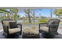 Inviting sunroom with cozy seating and serene water views through large windows, creating a relaxing retreat at 222 Mar St, St Pete Beach, FL 33706