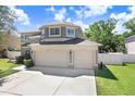 Two-story home featuring a three-car garage and large driveway at 2712 Avon River Dr, Valrico, FL 33596