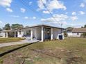 Charming home with a covered carport and well-manicured lawn with an inviting white exterior at 2901 W Nassau St, Tampa, FL 33607