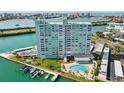 Gorgeous aerial view of the high rise with pool, boat docks and bay views at 31 Island Way # 106, Clearwater Beach, FL 33767