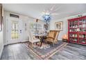 Well-lit dining area with large window, stylish decor, and beautiful hardwood floors at 3206 W Lemon St, Tampa, FL 33609