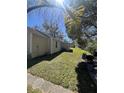 A well-maintained backyard featuring lush green grass and mature trees providing ample shade and curb appeal at 37324 Rose Ave, Dade City, FL 33523