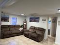 Living room featuring tile floors, white walls and brown sofas at 37324 Rose Ave, Dade City, FL 33523