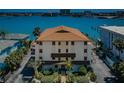 Aerial view of a well-maintained condo building with lush landscaping and waterfront access at 479 E Shore Dr # 8, Clearwater, FL 33767