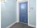 A view of the unit entry door featuring neutral paint and new hardware at 5220 Brittany S Dr # 309, St Petersburg, FL 33715