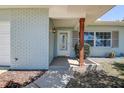 Inviting entryway featuring brick accents and a covered porch, offering curb appeal at 10915 Hammock Dr, Largo, FL 33774