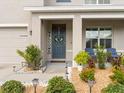 Inviting front porch with seating, a 'Welcome' sign, and lovely landscaping, creating a warm entrance at 11617 Miracle Mile Dr, Riverview, FL 33578
