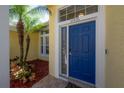 Bright yellow home exterior featuring a stylish navy blue front door at 12406 Bristol Commons Cir, Tampa, FL 33626