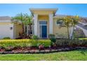 Close-up of the front door with manicured garden and stone border at 12406 Bristol Commons Cir, Tampa, FL 33626
