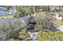 Aerial view of home featuring solar panels and a private lot with mature trees at 12705 Longcrest Dr, Riverview, FL 33579