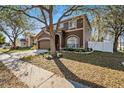 Charming two-story home with landscaped front yard and inviting curb appeal at 12705 Longcrest Dr, Riverview, FL 33579