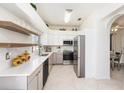 Bright kitchen with stainless steel appliances, sleek white cabinets, and quartz countertops at 12705 Longcrest Dr, Riverview, FL 33579