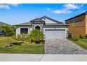 Inviting single-story home with well-kept landscaping, a two-car garage, and charming stone accents at 12730 Oak Hill Way, Parrish, FL 34219