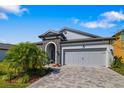 Charming single-Gathering home with well-manicured lawn and a two-car garage and beautiful stone accents at 12730 Oak Hill Way, Parrish, FL 34219
