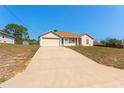 Charming single-story home with an attached two-car garage and extended driveway at 13191 Siam Dr, Spring Hill, FL 34609