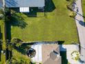 Aerial view showcasing a large, well-maintained yard and a neighboring property at 15822 Redington Dr, Redington Beach, FL 33708