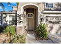 Close-up of the front door with an arched entryway and manicured landscaping at 20427 Carolina Cherry Ct, Tampa, FL 33647
