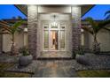 Eye-catching front entrance with stone accents, stylish lighting, and decorative potted greenery at 217 Manatee Rd, Belleair, FL 33756