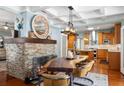 Elegant dining area with a fireplace and views to the kitchen at 235 Aberdeen St, Dunedin, FL 34698