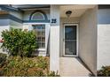 Inviting entryway featuring well-maintained landscaping and clear house number at 2749 Countryside Blvd # 28, Clearwater, FL 33761