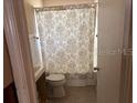 Bathroom featuring a toilet and shower with decorative curtain at 3001 57Th S St, Gulfport, FL 33707
