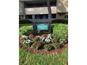 Community sign amid colorful flowers and greenery provides a warm welcome to Carnoustie Lodge at 36750 Us Highway 19 N # 3-210, Palm Harbor, FL 34684