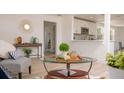 Bright living room featuring modern decor, a glass coffee table, and stylish furnishings at 4586 12Th N Ave, St Petersburg, FL 33713