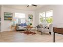 Sun-filled living room with neutral tones, large windows, and comfortable seating arrangements at 4586 12Th N Ave, St Petersburg, FL 33713