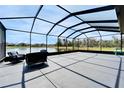Expansive screened patio offering ample space for entertaining and relaxing, with serene water views at 4904 Eagle Rock Dr, Wimauma, FL 33598