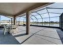 Enjoy outdoor living on this screened patio with a scenic water view and dining area at 4904 Eagle Rock Dr, Wimauma, FL 33598