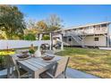 Backyard with a dining table, pergola with seating and a multi-story building at 5713 23Rd S Ave, Gulfport, FL 33707