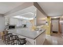 Bright and open kitchen with breakfast bar and white cabinets, flowing into the dining area at 6701 River Run Blvd, Weeki Wachee, FL 34607