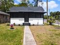 Charming front exterior view of home with screened porch and landscaped yard at 710 Seminole, Clearwater, FL 33755