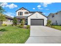 Beautiful two-story home features a well-maintained lawn and a modern farmhouse design at 8337 Abalone Loop, Parrish, FL 34219