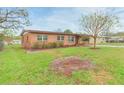 Quaint brick home with a green lawn and minimal landscaping at 9611 Pine Ridge Ave, Riverview, FL 33578