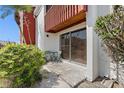 Cozy outdoor patio with seating, offering a relaxing space with nearby greenery and sliding glass door at 1055 82Nd N Ter # 1055A, St Petersburg, FL 33702