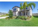 Beautiful home has manicured lawns and landscaping, and a paver driveway with a two car garage at 10934 Sundrift Dr, Tampa, FL 33647