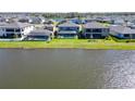 Beautiful lake view homes featuring screened-in pools and lush green lawns at 12851 Tortoise Shell Pl, Riverview, FL 33579