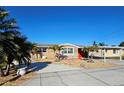 Inviting single-story home with a well-manicured yard and convenient carport parking at 13633 Britton Dr, Hudson, FL 34667