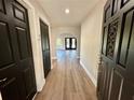 Inviting entryway features stylish black doors and beautiful new flooring at 13969 Gull Way, Clearwater, FL 33762