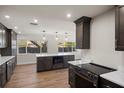Modern kitchen with stainless steel appliances, a center island, and sleek countertops at 13969 Gull Way, Clearwater, FL 33762
