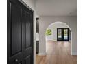 Bright, open living room featuring hardwood floors and an arched entryway at 13969 Gull Way, Clearwater, FL 33762