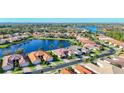 Panoramic aerial view of a lakeside community with mature trees and stunning water views at 16145 Amethyst Key Dr, Wimauma, FL 33598
