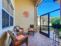 Relaxing screened-in lanai with comfortable seating and brick-paver flooring at 16145 Amethyst Key Dr, Wimauma, FL 33598