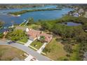 Aerial view of home by waterfront with lush greenery and beautiful landscaping at 2005 N Pointe Alexis Dr, Tarpon Springs, FL 34689