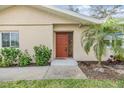 Inviting front entry featuring a well-maintained walkway and a vibrant palm tree at 217 2Nd Sw St, Largo, FL 33770
