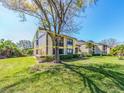 Charming two-story condo with a well-maintained lawn and mature landscaping on a sunny day at 226 Woodlake Wynde, Oldsmar, FL 34677